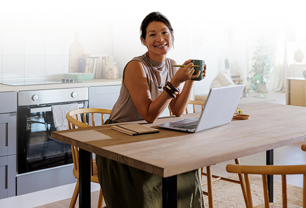 Woman with coffee at the kitchen table