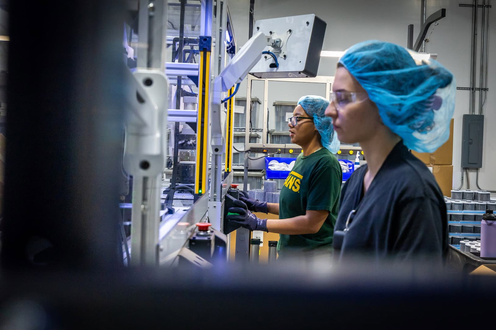 Production team members inspecting and assembling Pure XP water filters.