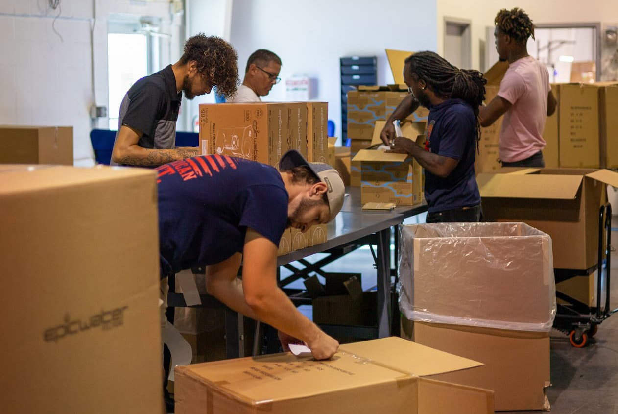 Warehouse team packing and preparing Epic Water Filters orders for shipping.