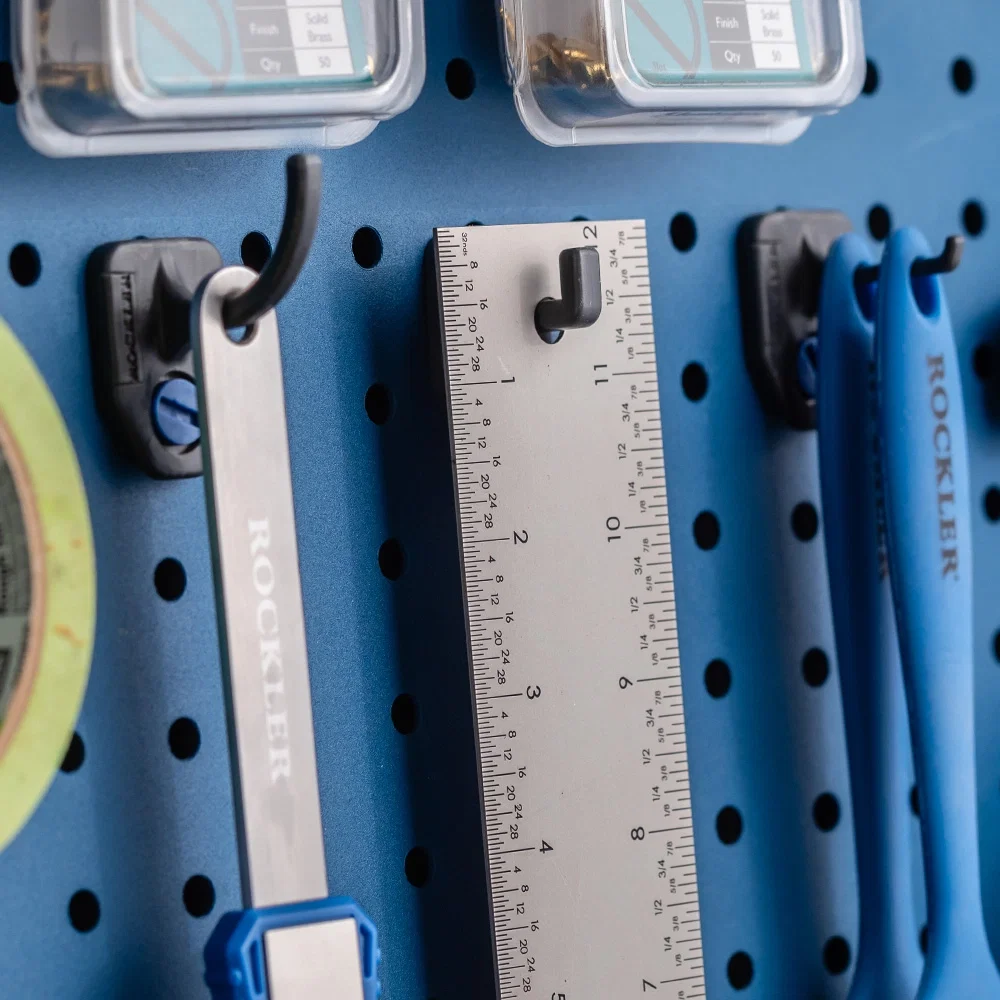 Measuring and gluing tools hanging on a pegboard rack