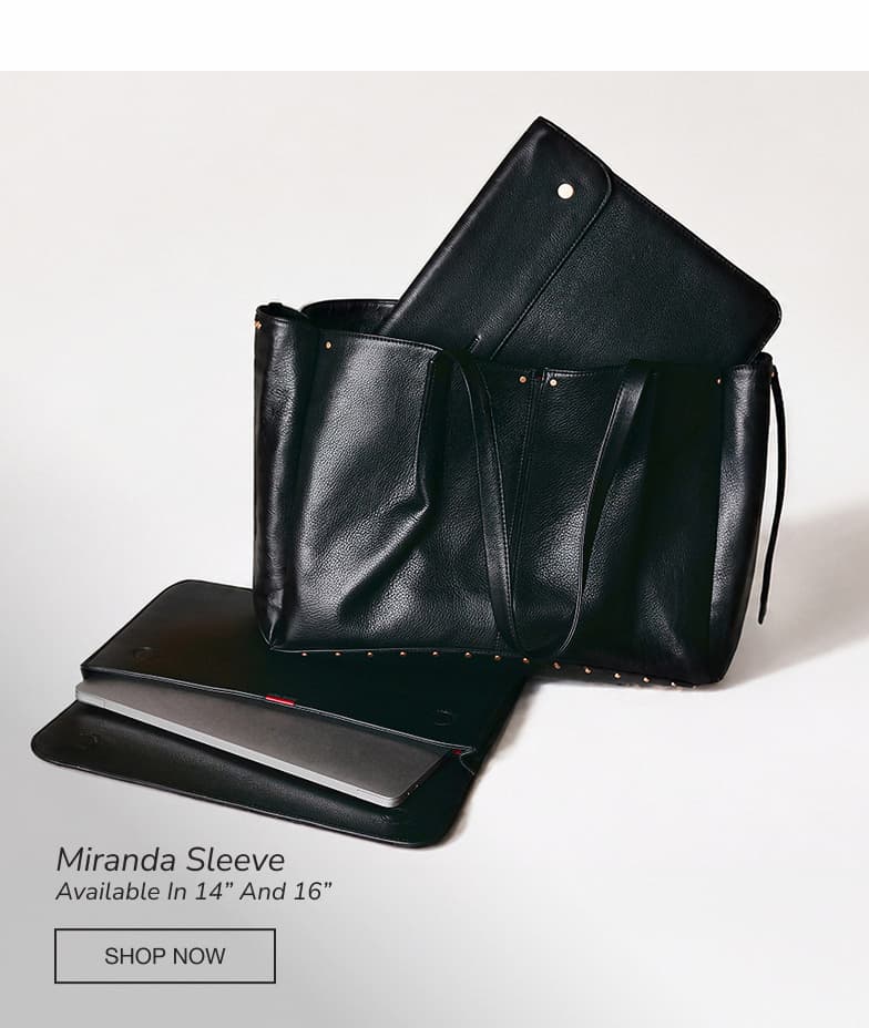 The Hammitt Miranda Sleeve in black leather, available in 14-inch and 16-inch sizes, displayed partially inside the Hammitt Meryl Carryall in black pebbled leather, showcasing a work-ready setup for carrying a laptop and daily essentials.