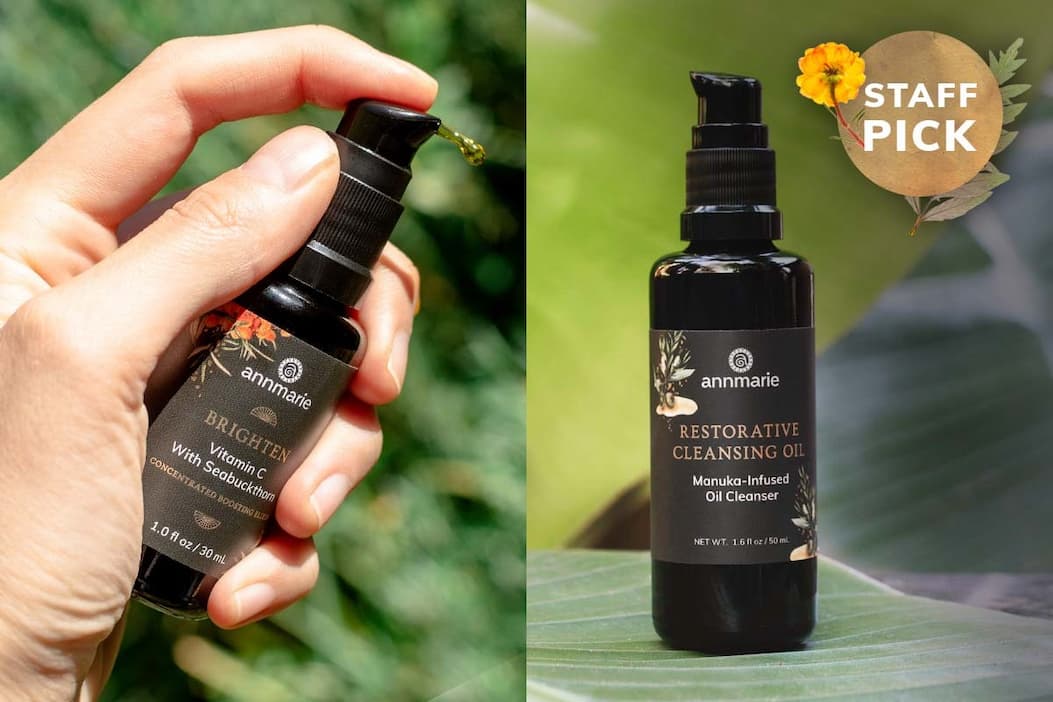 The the left, we have a hand pumping the Bright Elixir (30ml), and to the right we have the bottle of the Restorative Cleansing Oil (100ml) resting on a leaf. 