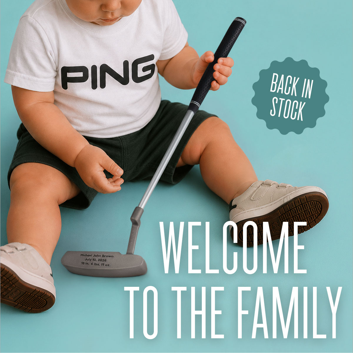 Baby holding the My First PING Putter, wearing the matching shirt.