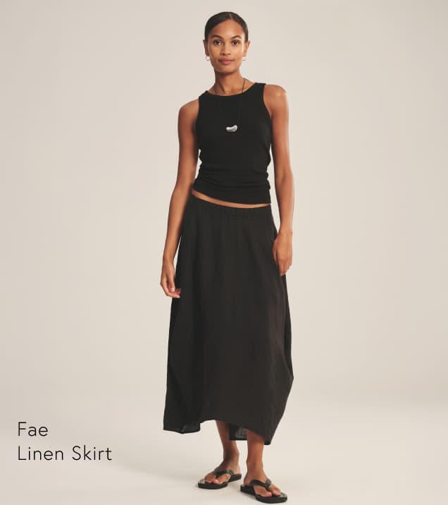 Image shows a model wearing the Fae Linen Skirt in Black.