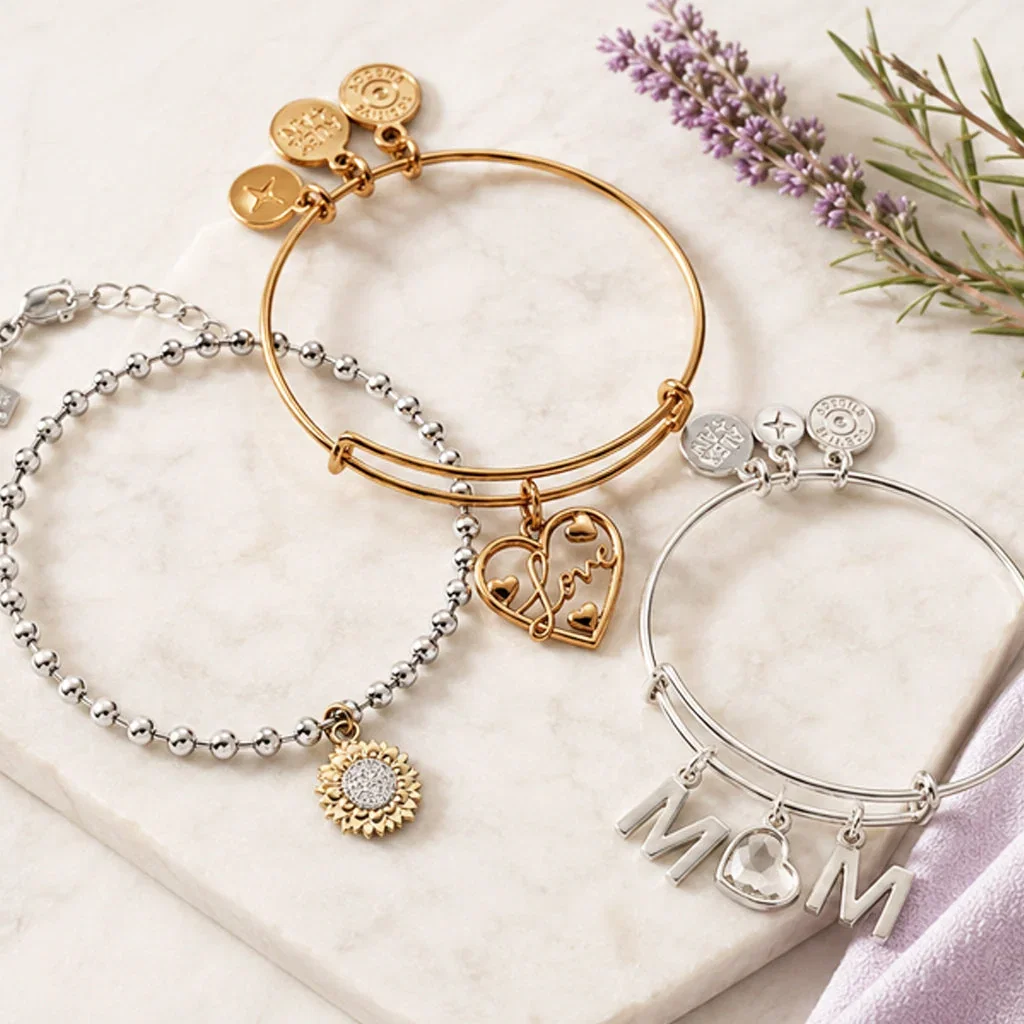 Three expandable bangle bracelets with meaningful charms including hearts, sunflower, and MOM lettering on marble surface.