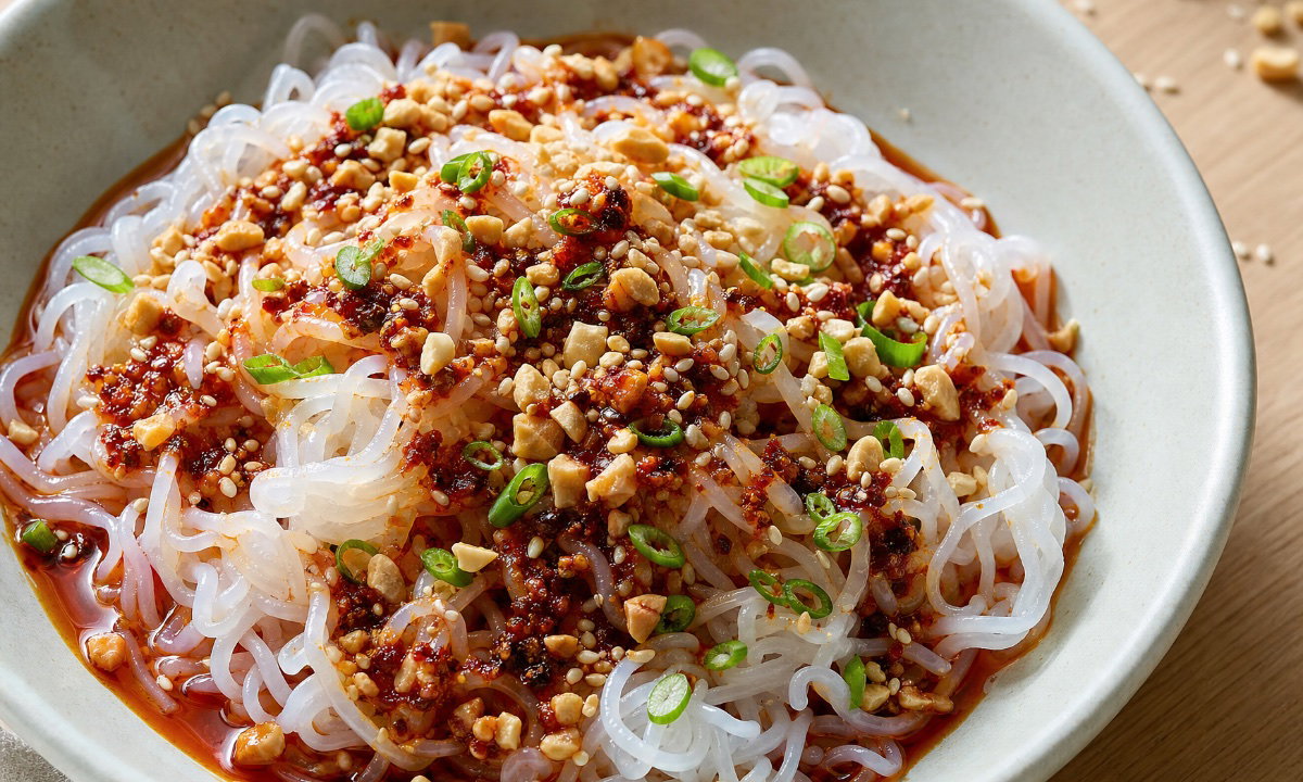Konjac fettuccine tossed with peanut, lime and chili crisp, topped with scallion