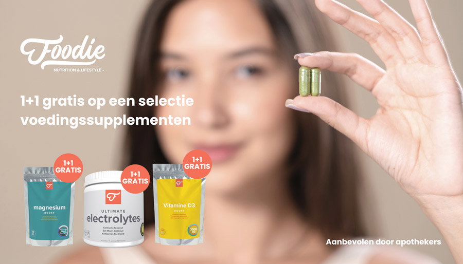 Blurred woman holding two green supplement capsules, Foodie supplement pouches and jar below with 1+1 gratis promotional badge