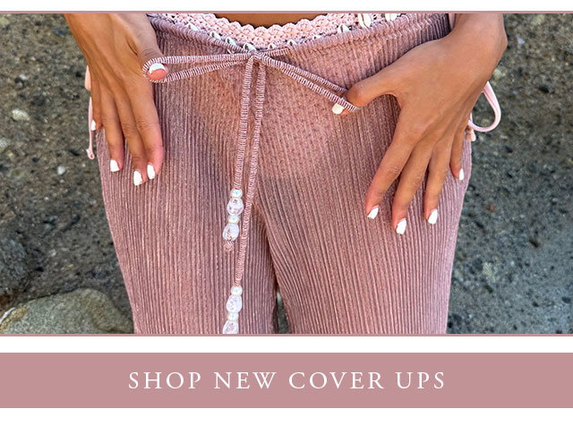 Model wearing a pink seashell bikini and sheer cover up pants. Shop new cover ups.