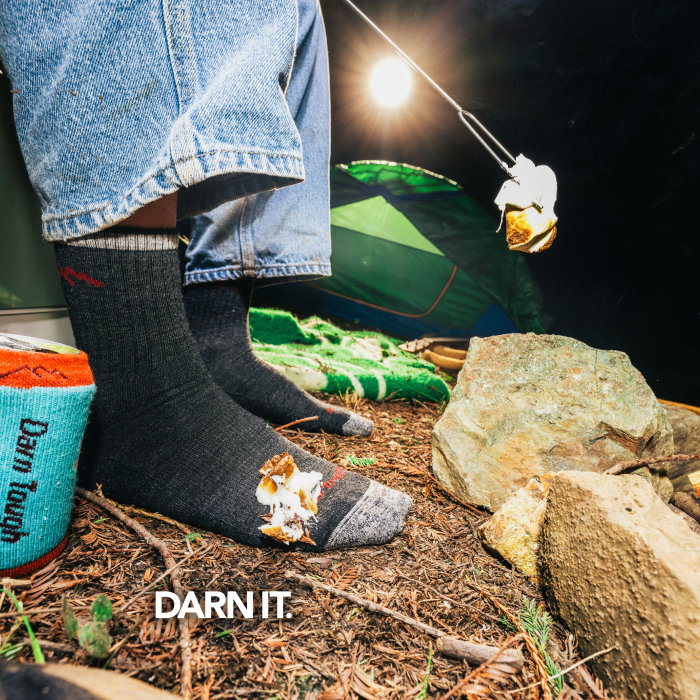 Shop with Free Shipping - Darn It: a marshmallow drips off the roasting stick onto a black Darn Tough sock