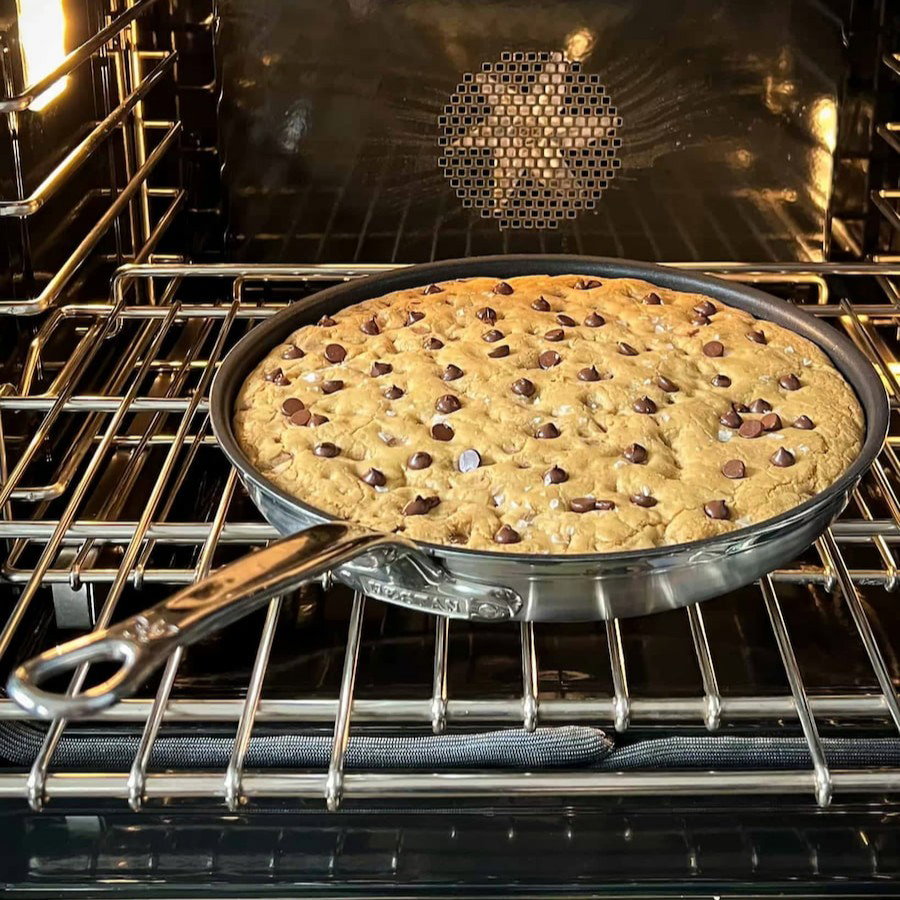 IMG: Chocolate chip cookie in a Hestan ProBond Luxe® Polished Clad Stainless Steel Skillet with TITUM® Nonstick inside an oven