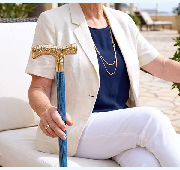 woman holding brass cane