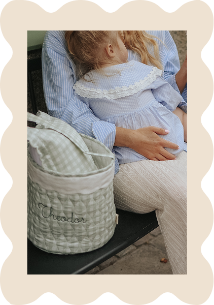 child sitting on woman's lap with a basket