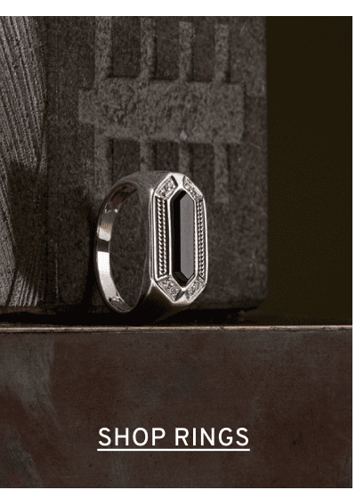 A men’s statement ring with a black center stone. Click to Shop Rings
