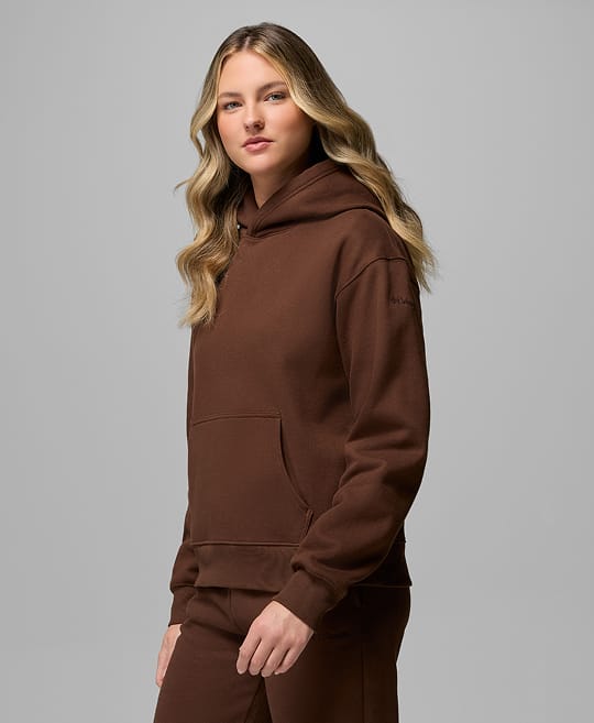 A woman wearing a brown sweat set.