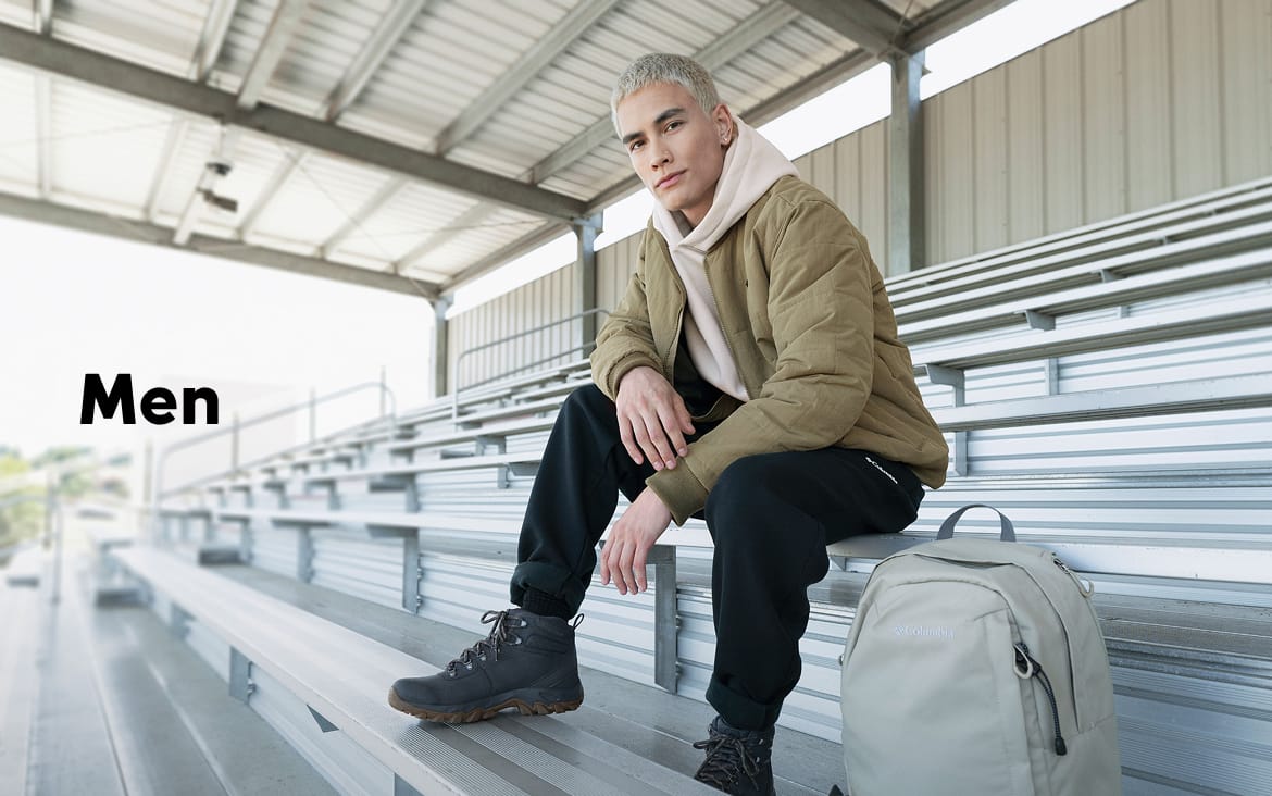 A young man sitting on school bleachers with a backpack with text: Men