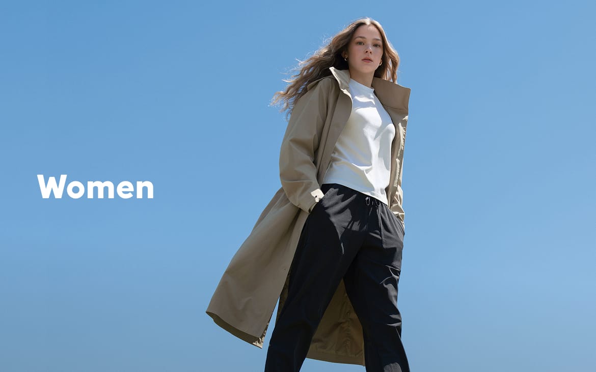 A young woman standing against a blue sky with text: Women