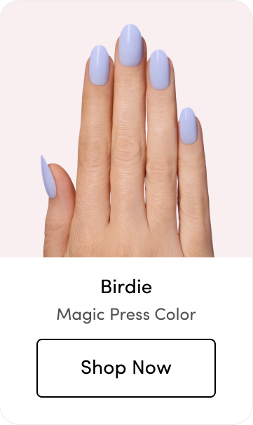 Hand with light periwinkle Magic Press press-on nails, labeled 