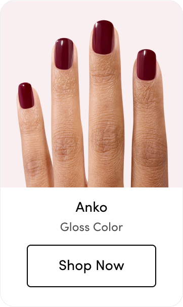 Hand with dark burgundy gloss nail polish, labeled 