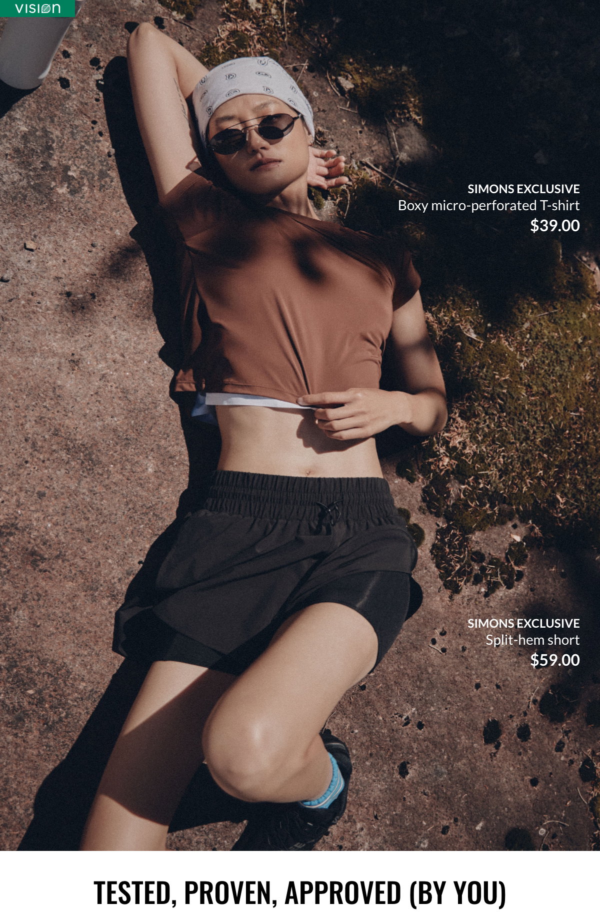A woman in a running outfit is laying on the ground in a forest. She's wearing a brown micro-perforated t-shirt, Simons exclusive, at $39.00 and black shorts with built-in bike short, Simons exclusive, at $59.00.