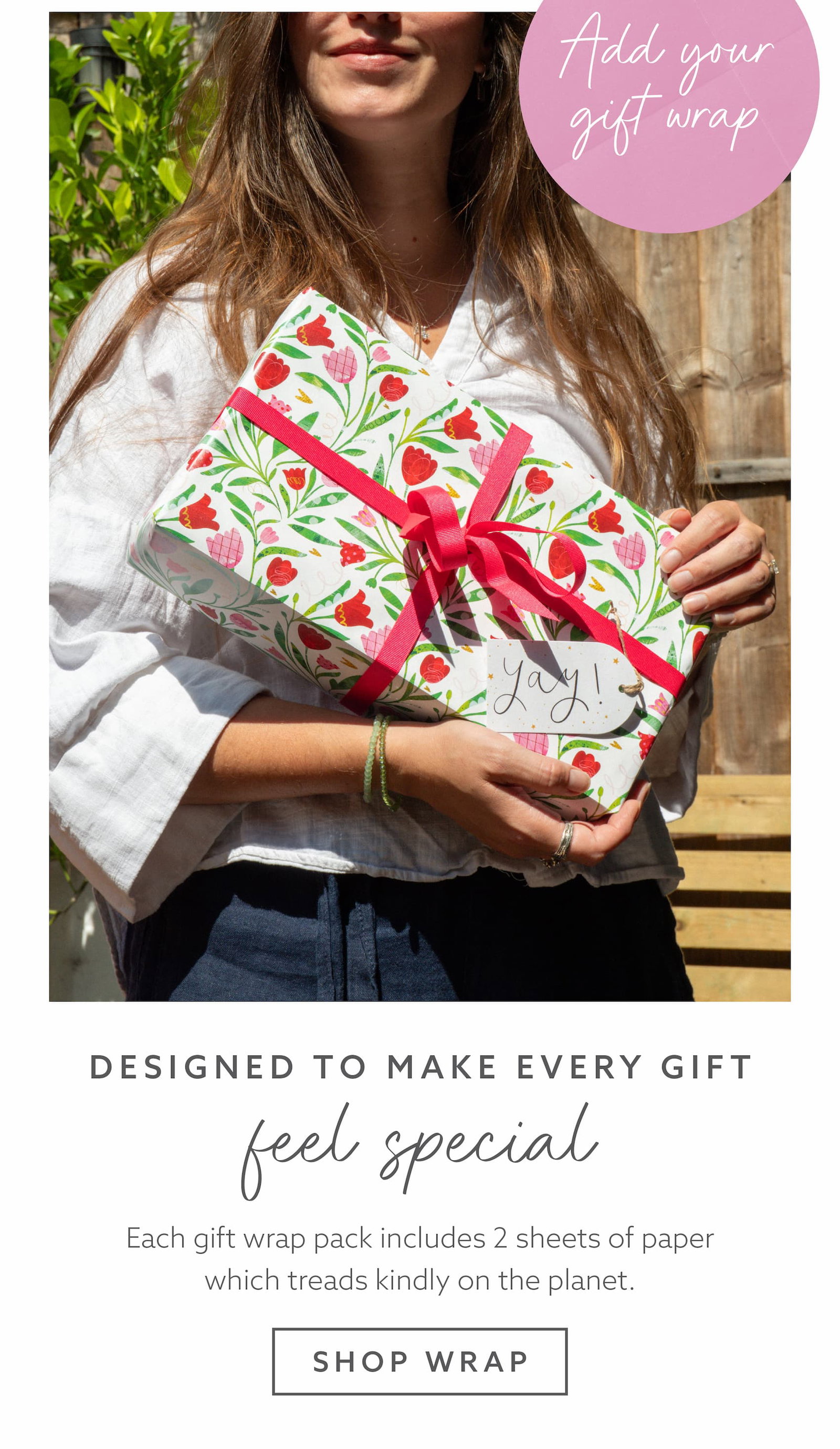 Wrapped gift featuring Whistlefish floral gift wrap and pink ribbon, showcasing eco-conscious gift wrapping designed to make every present feel special.