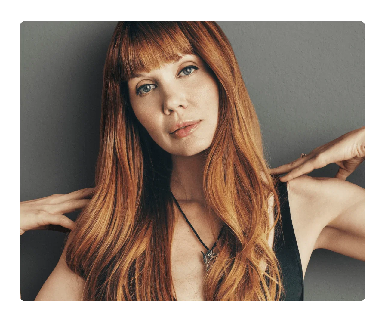 Close-up of a woman with long, flowing red hair.