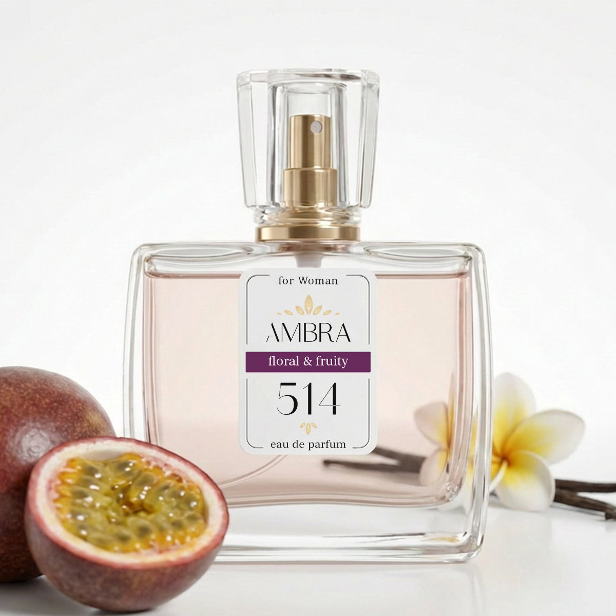 Glass perfume bottle labelled "AMBRA 514 floral & fruity" with pale pink liquid, halved passionfruit and plumeria flowers beside it