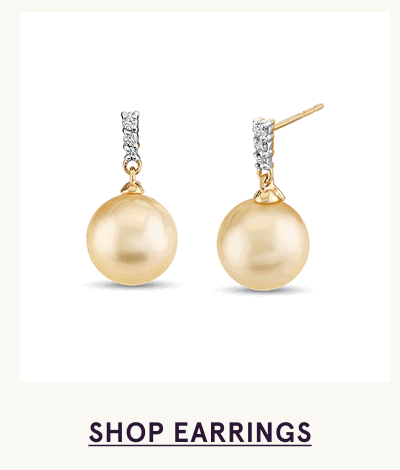 Gold drop studs with gold pearls hanging from diamond-encrusted posts. Click here to shop earrings