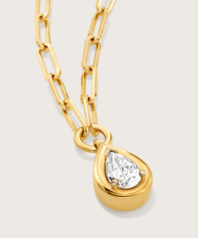 Yellow gold necklace featuring a bezel-set pear-shaped diamond.