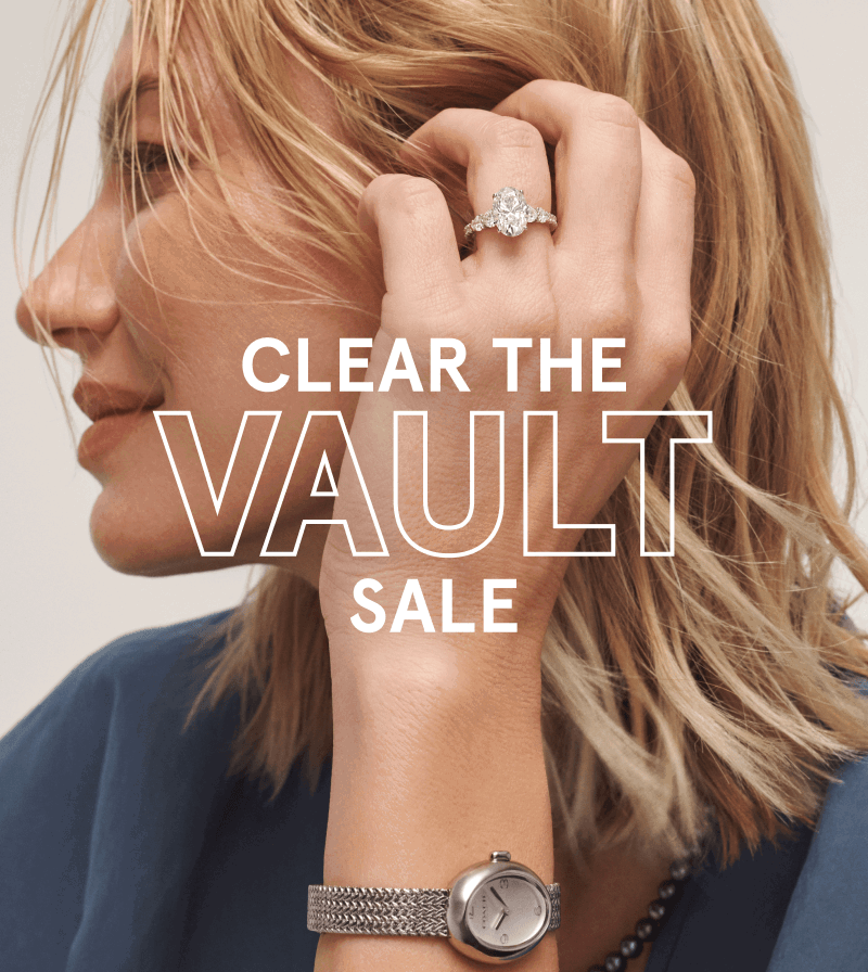 Woman wearing a diamond ring, a black pearl necklace and a silver watch. Clear the vault sale.