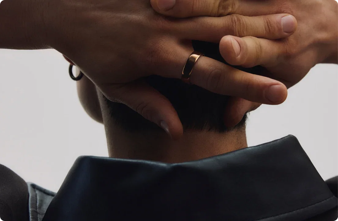 Person wearing Oura ring with hands behind their head