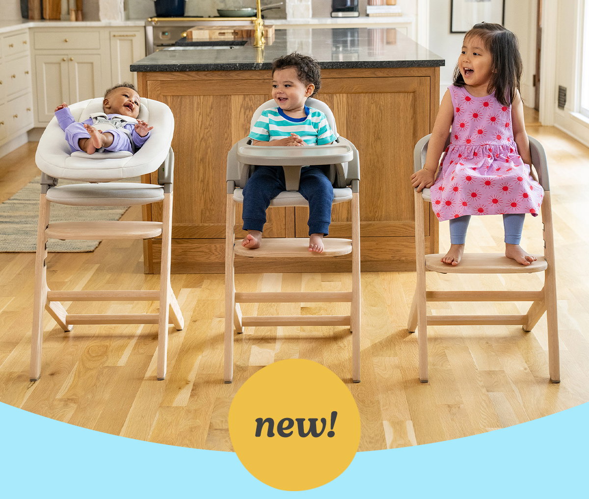 A newborn, a baby and a toddler each seated in Graco Close2Baby highchairs around a kitchen island. New!