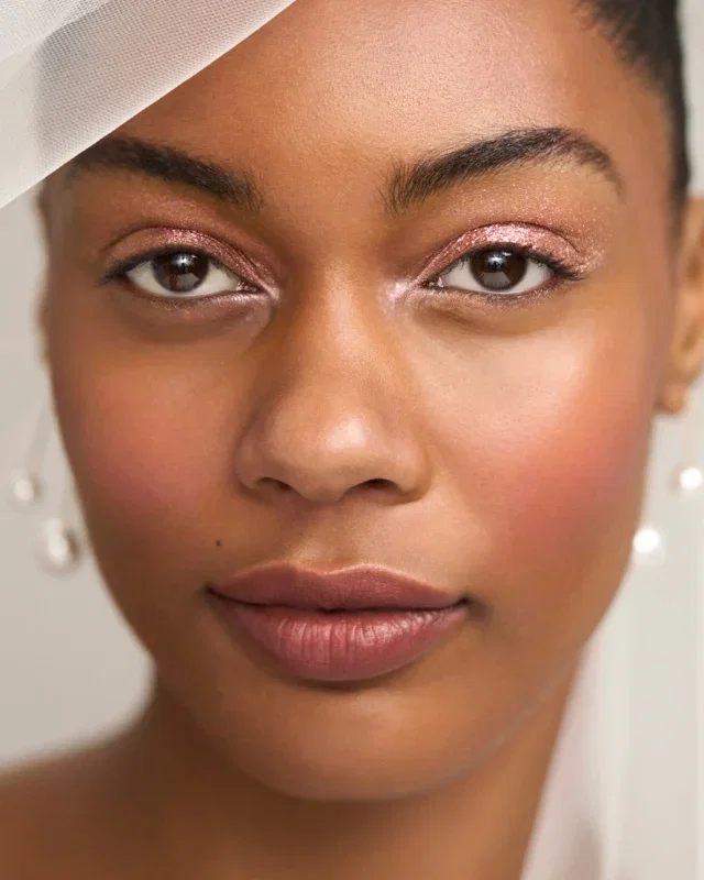 Close-up of a woman's face showing glowing skin.