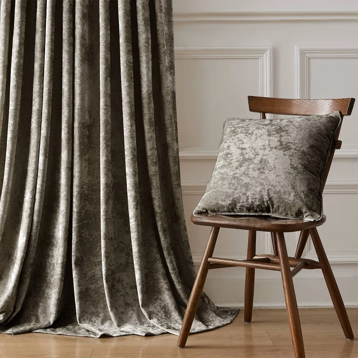 Victoria Royal crushed velvet drapery in stone gray with matching cushion on a wood chair