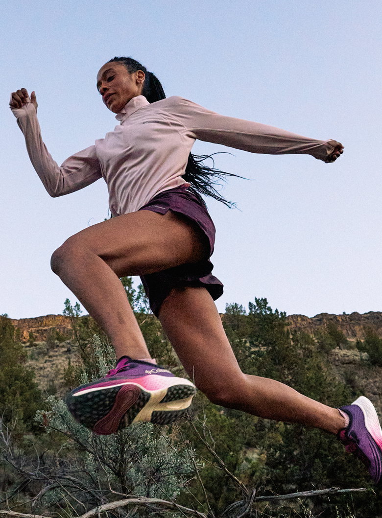 A trail runner jumping in the air mid stride. 