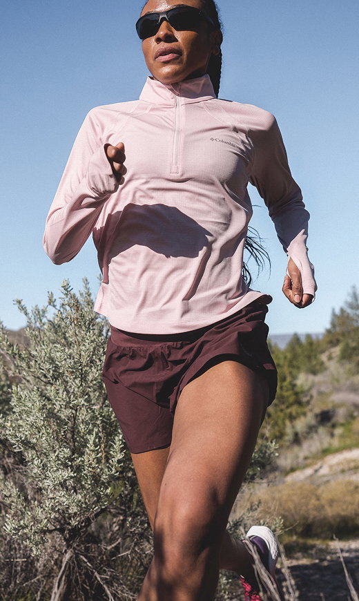A woman running on a trail. 