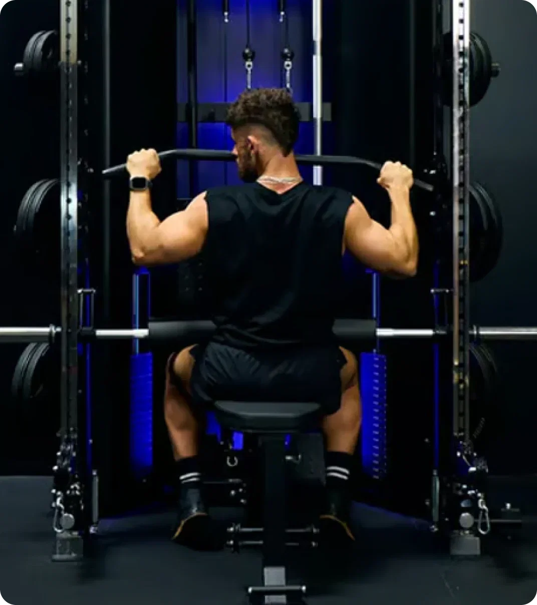 Man performing a seated strength exercise on a Force USA all-in-one trainer.