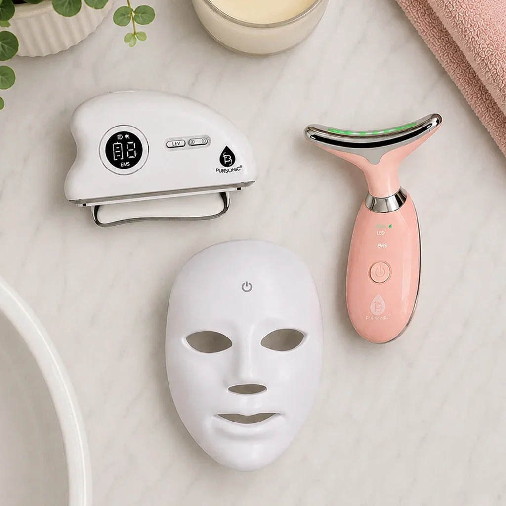 Pursonic Everyday Essentials skincare collection featuring LED face mask, sonic device, and neck lift tool on marble surface