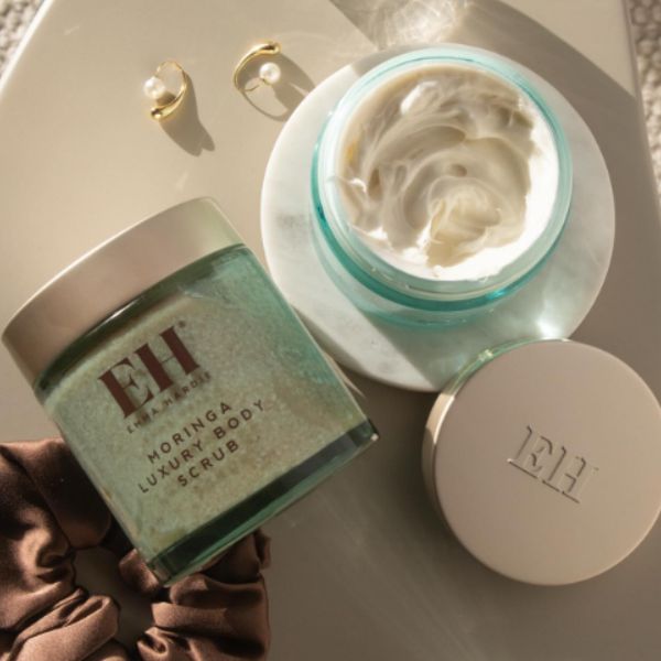 Emma Hardie Bath & Body products, including an open Moringa Body Scrub jar.