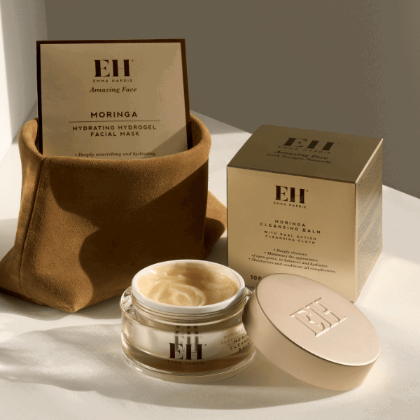 Emma Hardie Amazing Face skincare products with gift boxes and an open cream jar.
