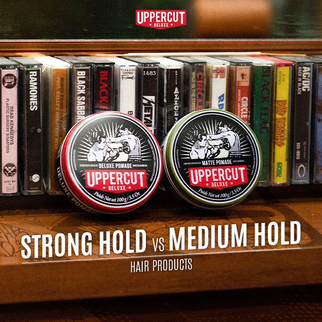 Uppercut Deluxe Pomade and Matte Pomade leaning on cassette tapes