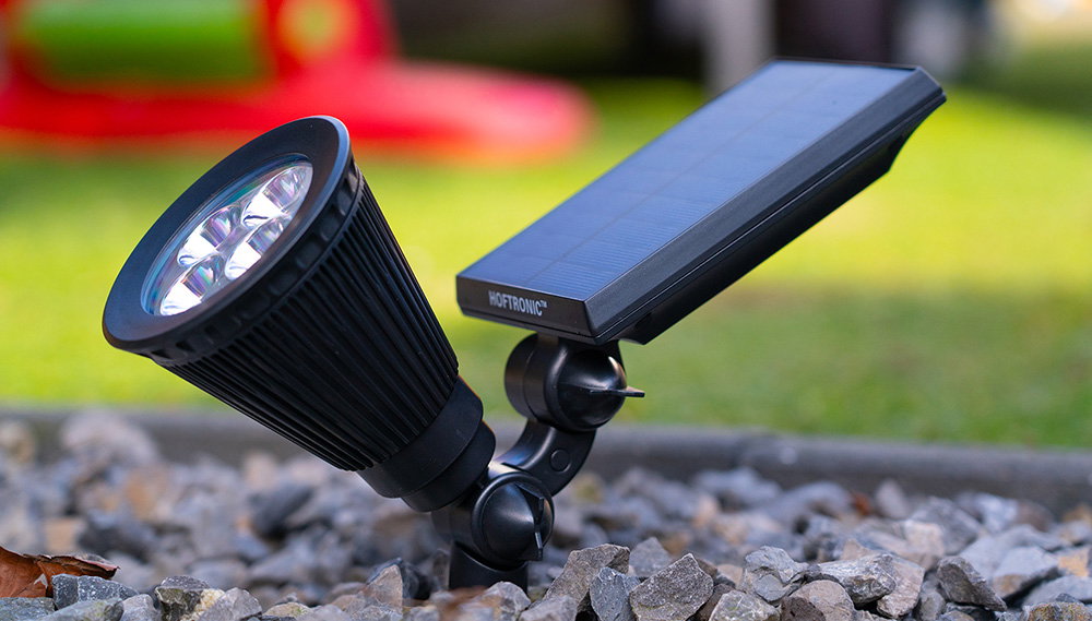 Bend solar PIR garden spike light in the ground, surrounded by pebbles