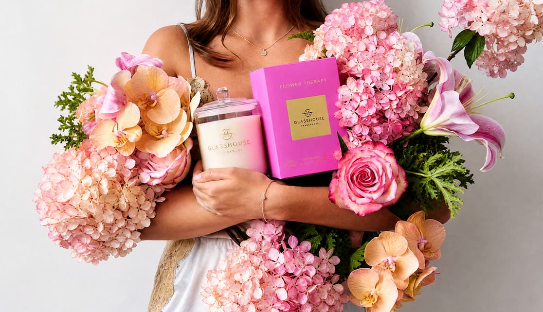 Women holding flowers and Flower Therapy candle