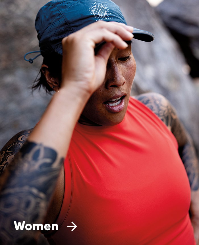 A woman wearing trail running gear in a desert with text: Women