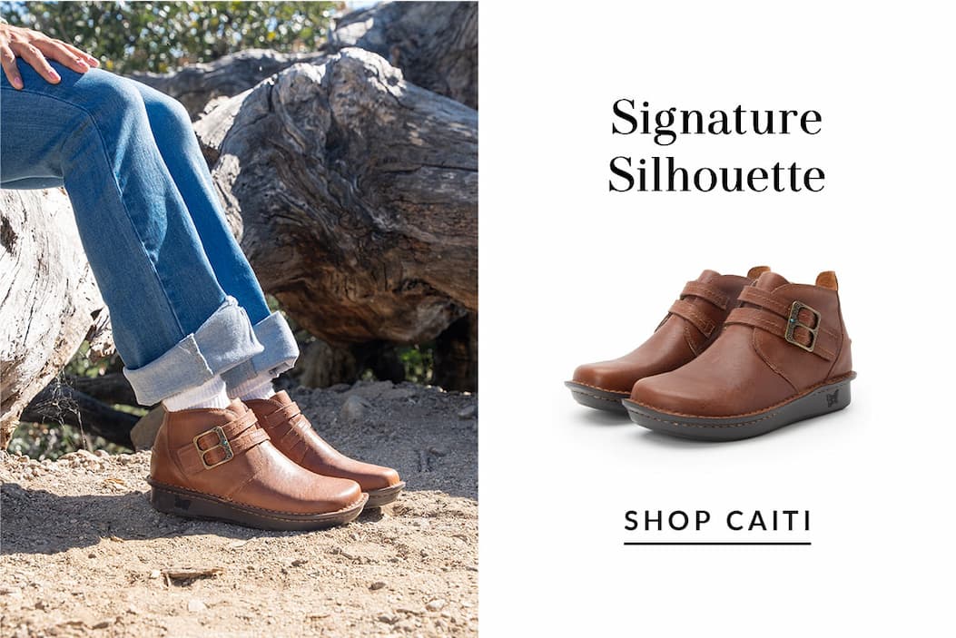 Signature Silhouette showcase displaying brown leather Caiti ankle boots with buckled straps on a white background and on a model outdoors in jeans. Text reads 'SHOP CAITI'.