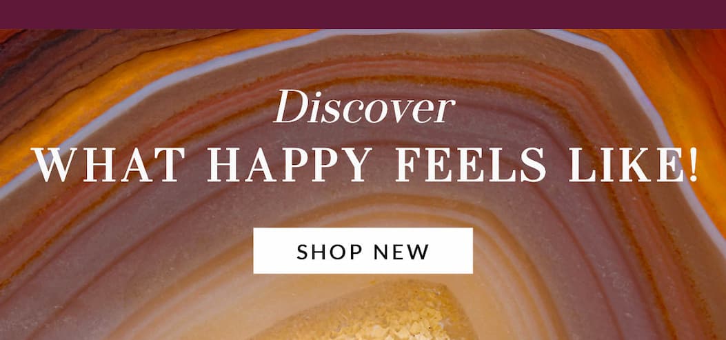 Decorative agate stone background with text that reads 'Discover WHAT HAPPY FEELS LIKE!' and a white button stating 'SHOP NEW'.