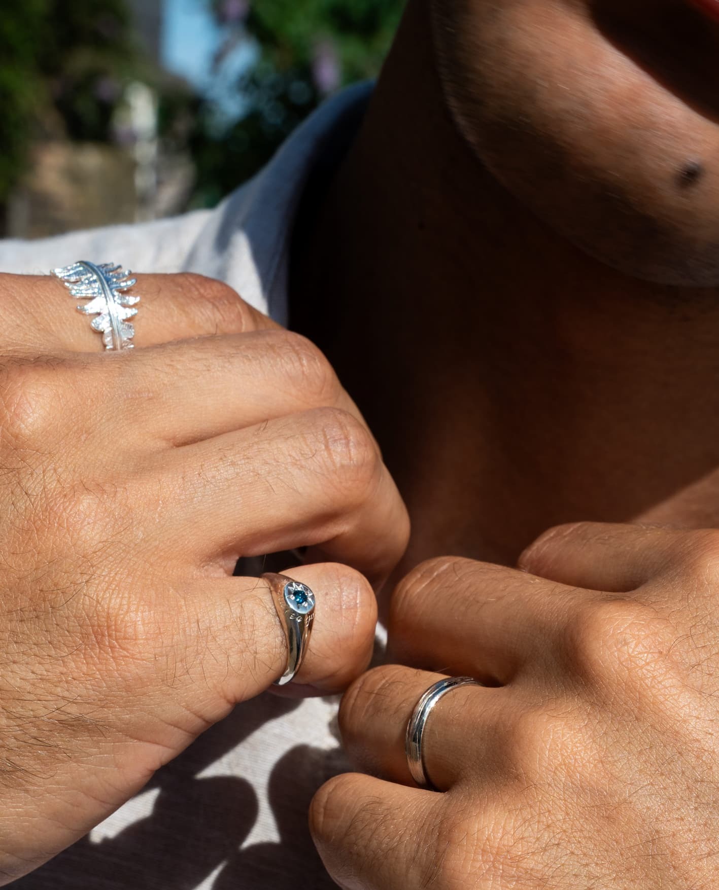Model wearing layered handcrafted silver jewellery with a white summer outfit.