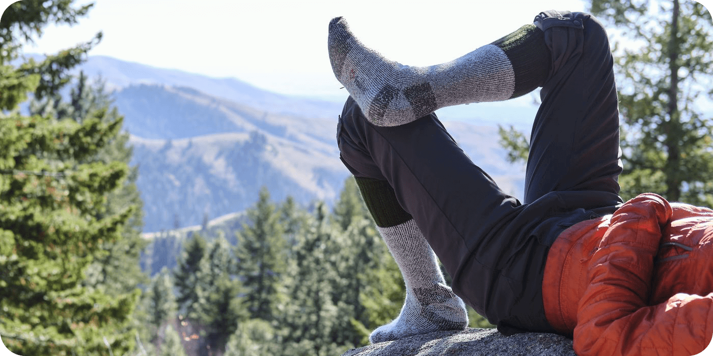 A hiker laying down on a large
boulder