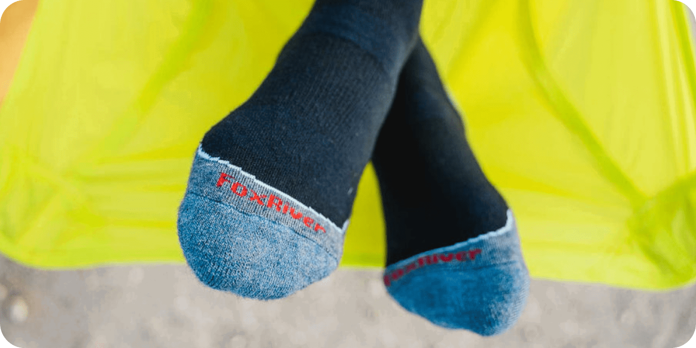 A close up
image of a pair of feet with Fox River socks on them