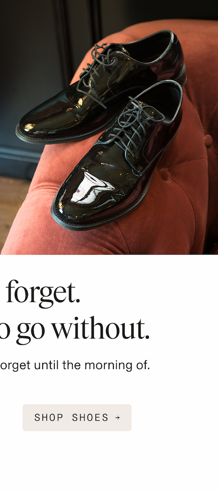 a pair of black patent leather dress shoes with laces, resting on a coral/terracotta velvet tufted chair. Copy reads: "Easy to forget. Impossible to go without." followed by "The essential pieces you forget until the morning of." Below is a button reading "SHOP SHOES →"