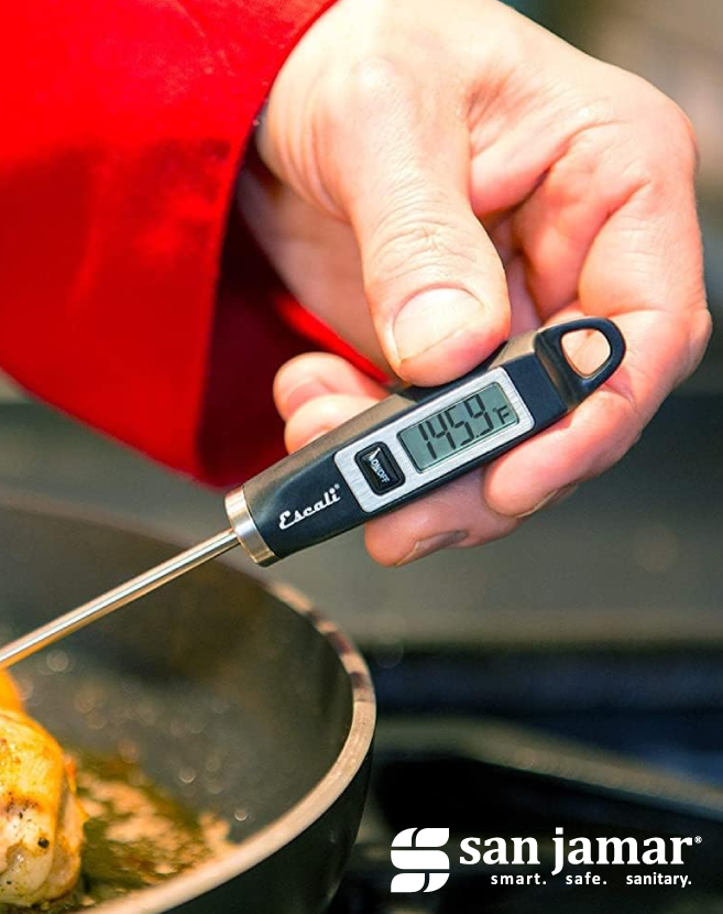 Escali digital probe thermometer being used to check the temperature of breaded food portions on a foil-lined baking tray, with San Jamar branding displayed in the corner.